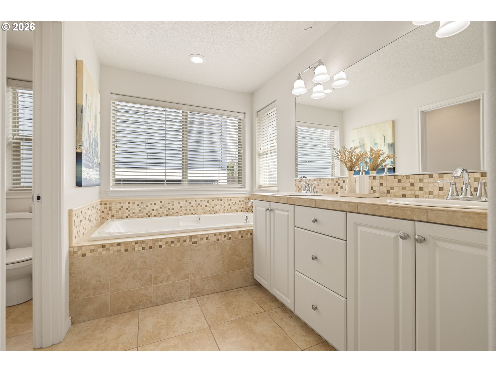 6512 Northwest 165th Avenue Portland, OR 97229 - Photo 21 of 42 a bathroom with a granite countertop sink a large mirror and a bathtub