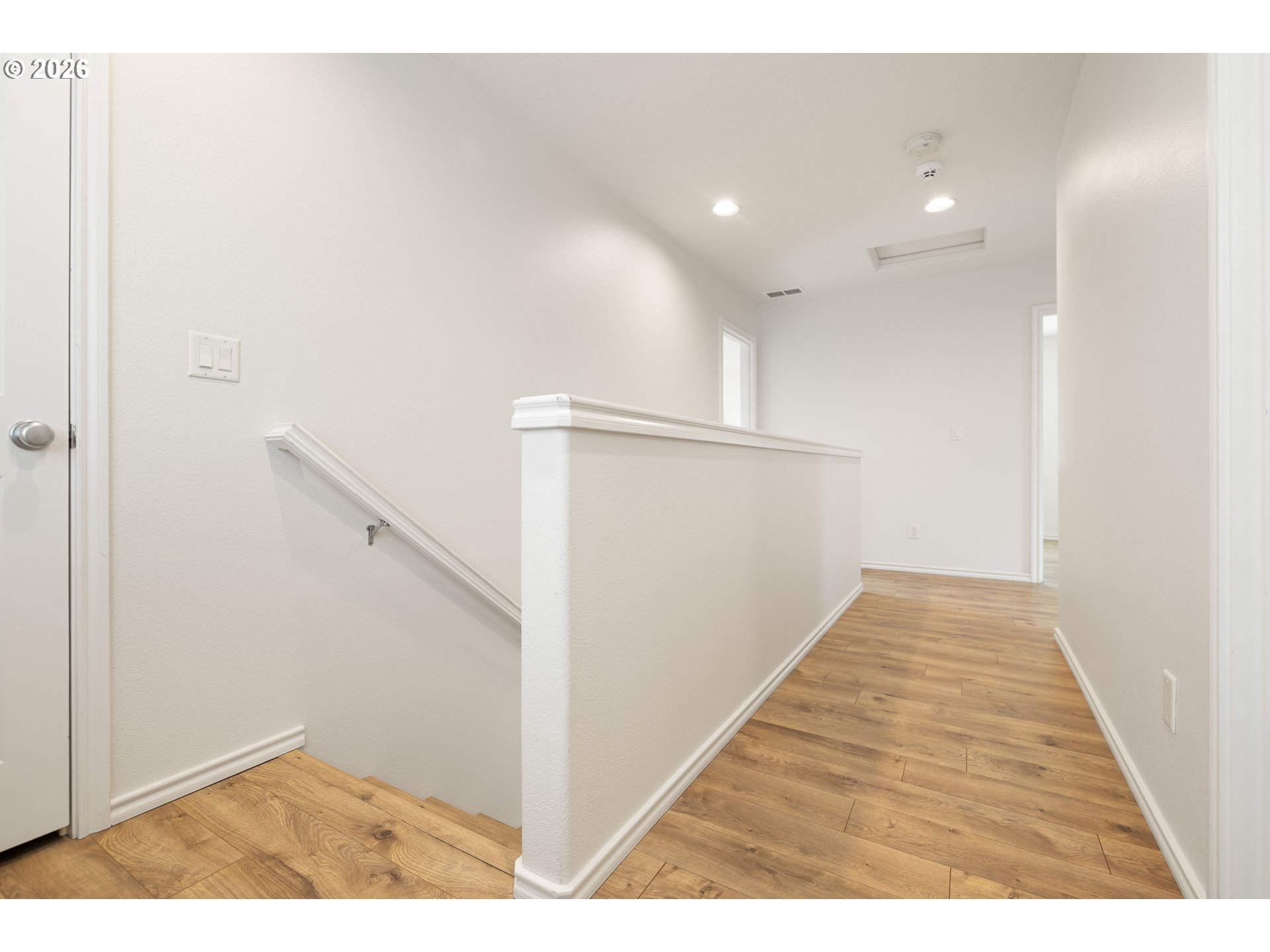 6512 Northwest 165th Avenue Portland, OR 97229 - Photo 27 of 42 a view of a hallway with wooden floor and entryway