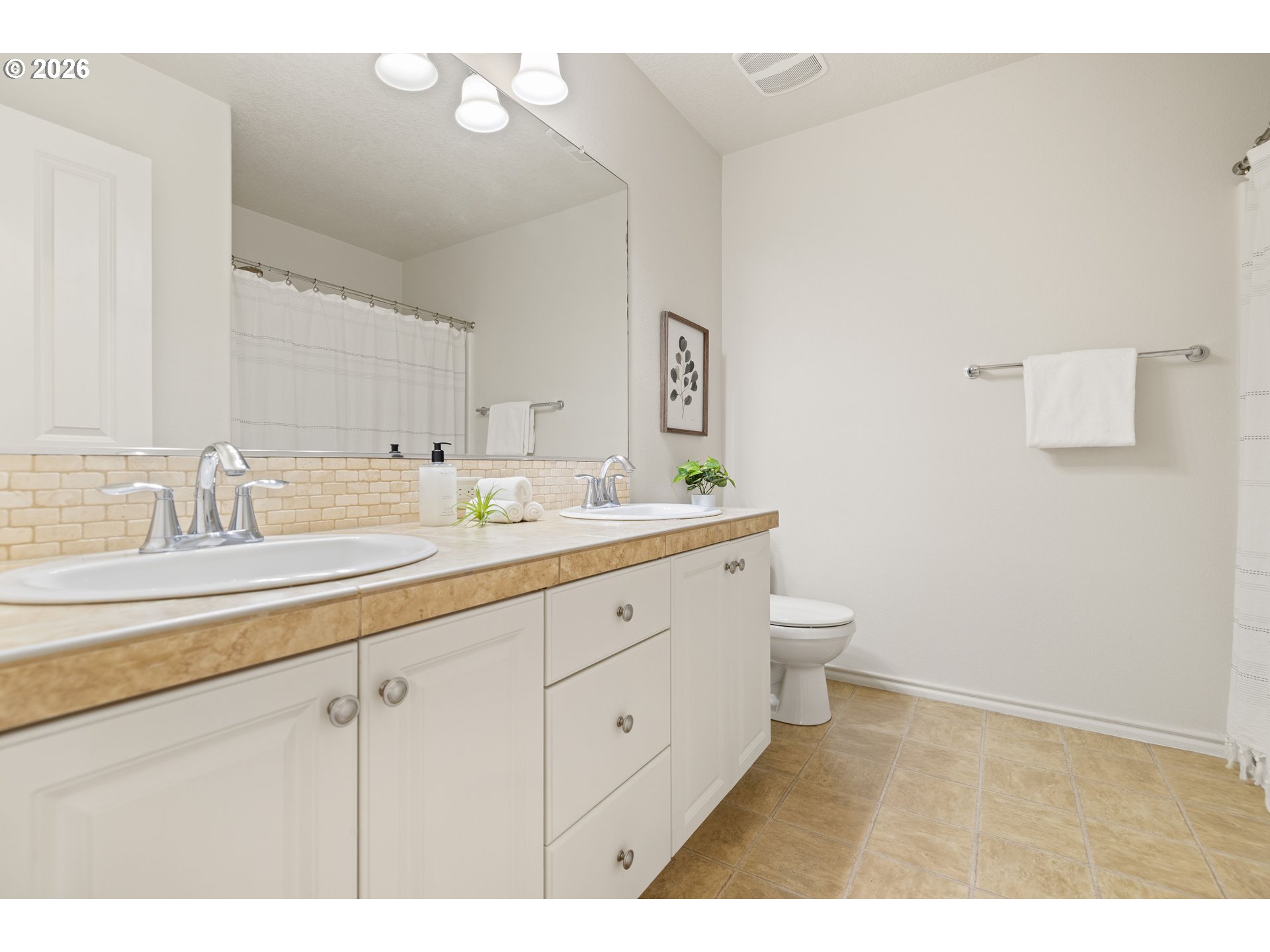 6512 Northwest 165th Avenue Portland, OR 97229 - Photo 28 of 42 a bathroom with a toilet sink and mirror