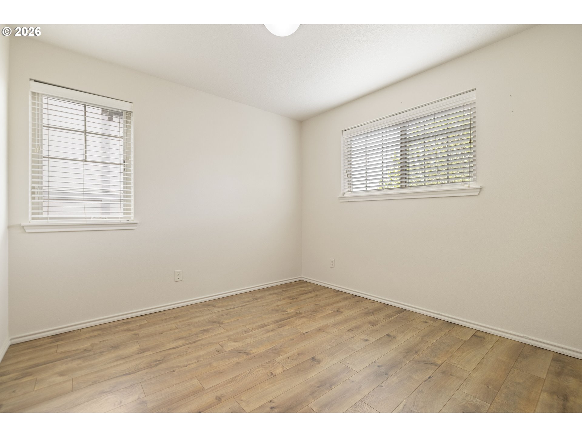 6512 Northwest 165th Avenue Portland, OR 97229 - Photo 31 of 42 an empty room with wooden floor and windows