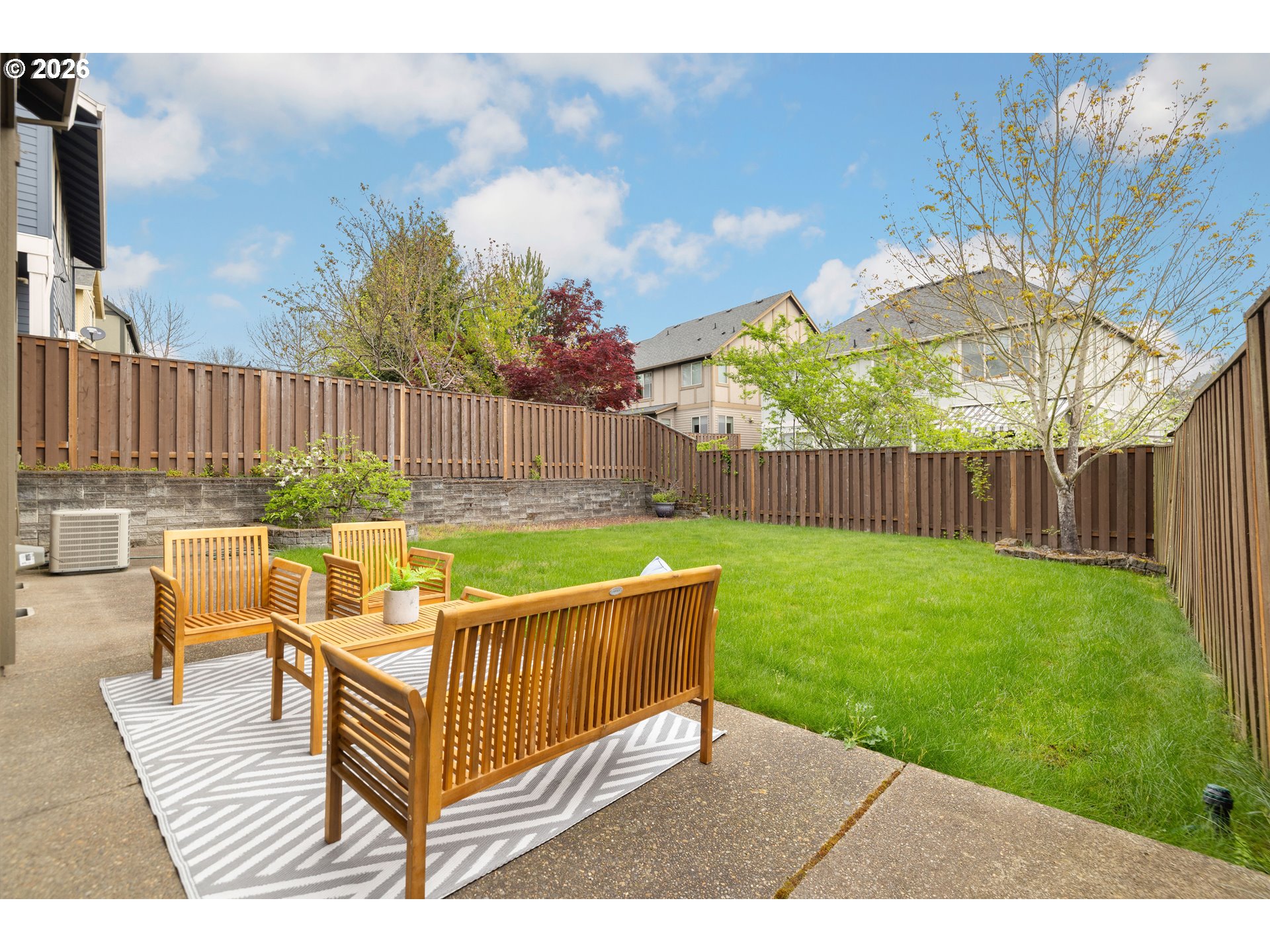 6512 Northwest 165th Avenue Portland, OR 97229 - Photo 35 of 42 a view of a backyard with table and chairs with wooden fence