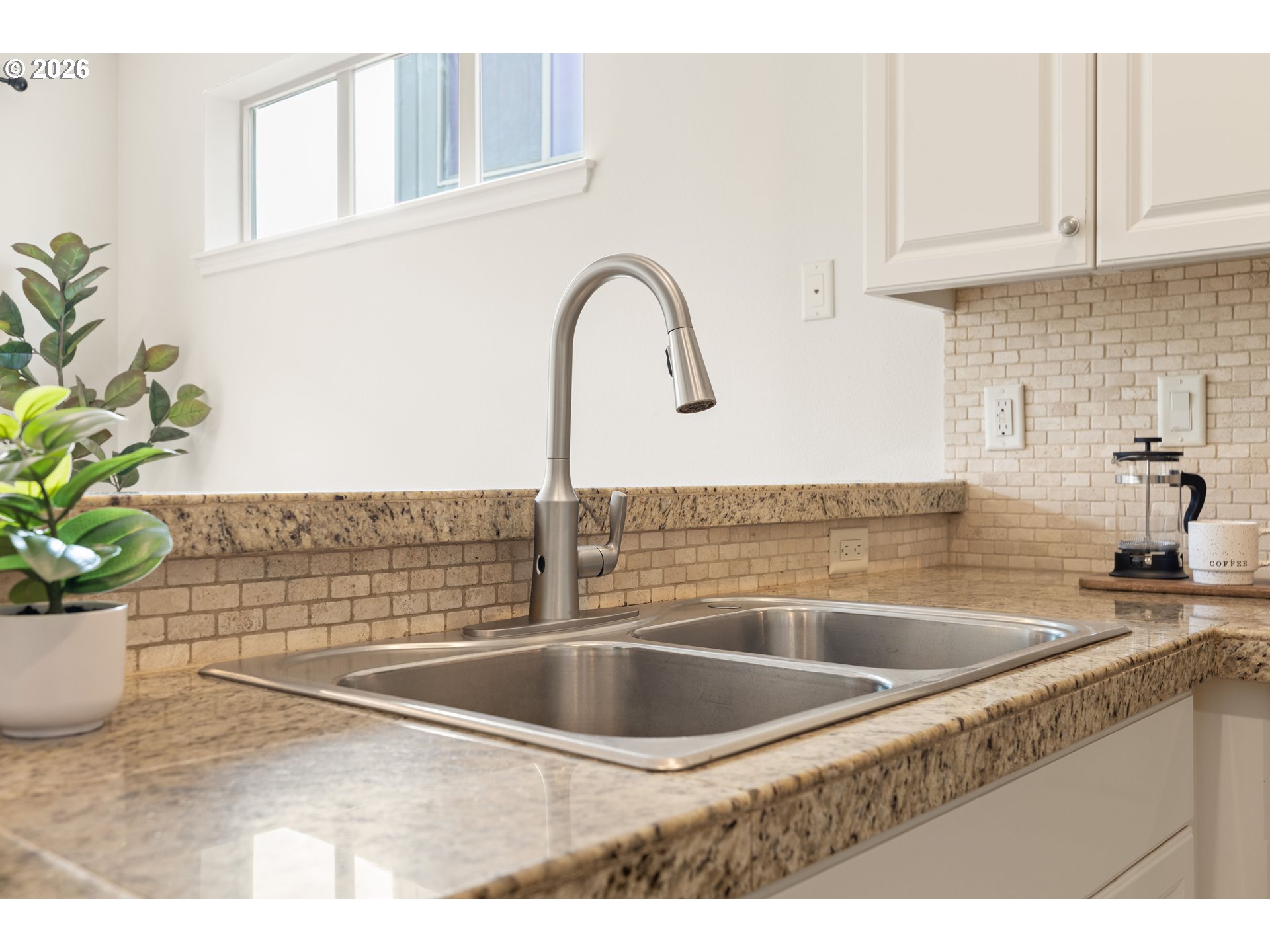 6512 Northwest 165th Avenue Portland, OR 97229 - Photo 10 of 42 a kitchen with a sink and a potted plant