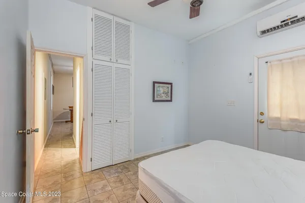 a bedroom with a bed and a table chair