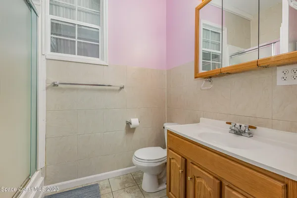 a bathroom with a sink a toilet and a shower