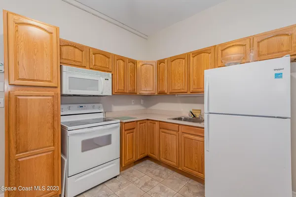 a white refrigerator freezer sitting in a kitchen