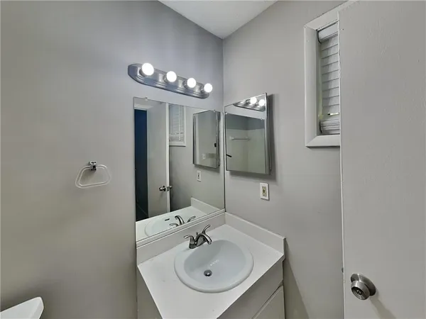 a white toilet sitting next to a bath tub