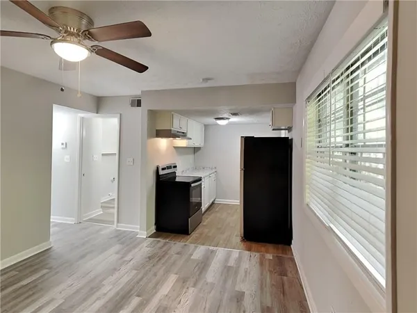 a view of a refrigerator in kitchen and wooden floor