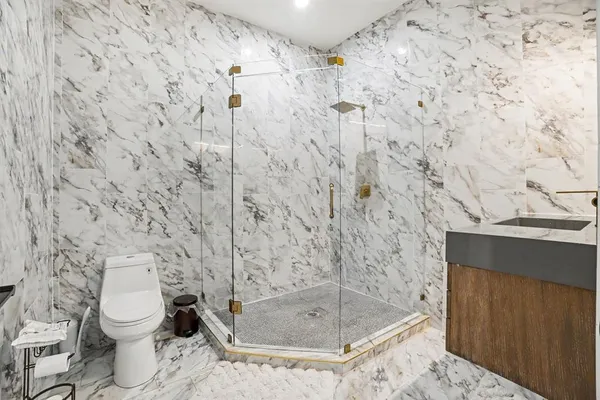 a bathroom with a toilet and a shower