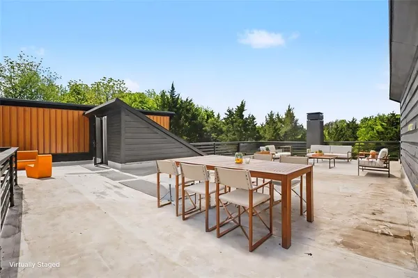 a backyard of a house with table and chairs