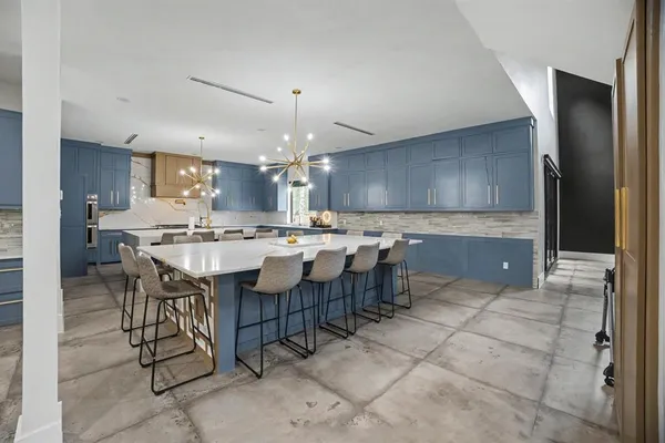 a large kitchen with a table and chairs