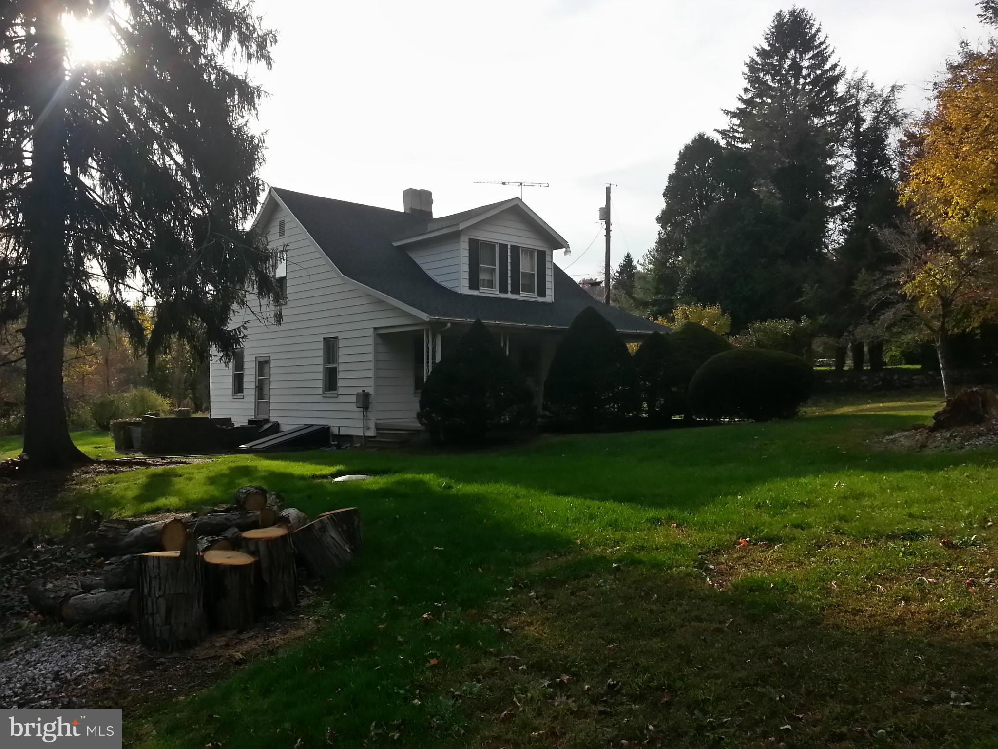 25307 Highfield Road Cascade, MD 21719 - Photo 1 of 16 a front view of a house with garden