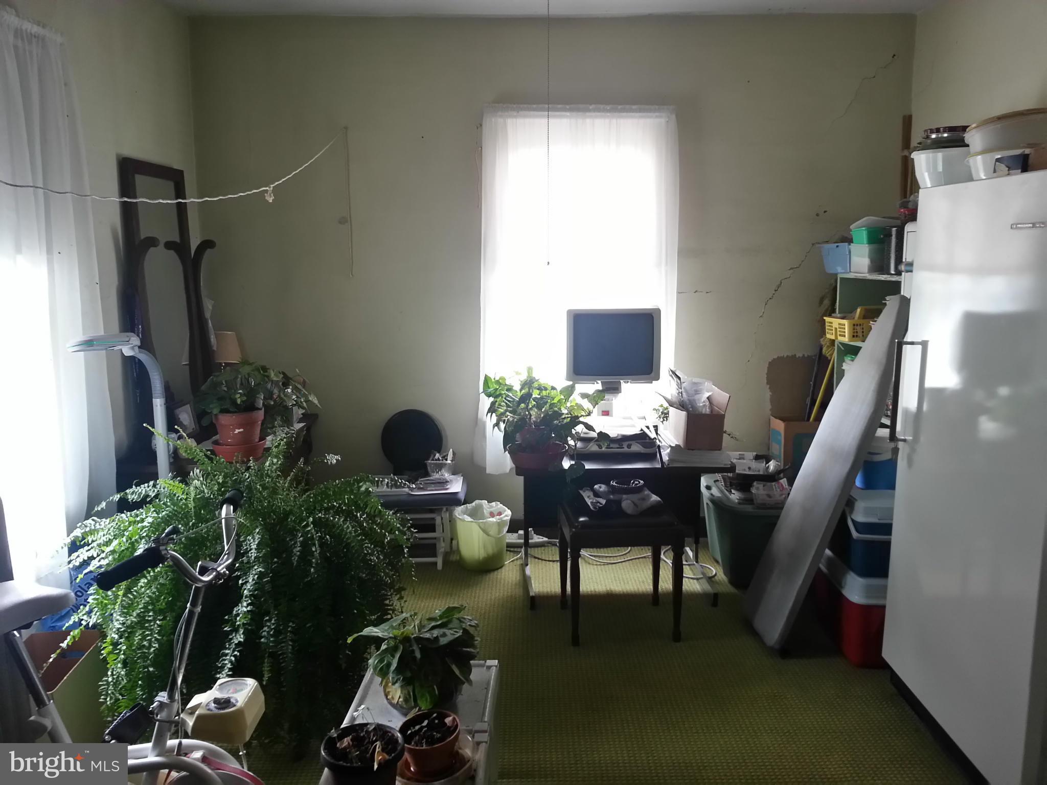 25307 Highfield Road Cascade, MD 21719 - Photo 7 of 16 a view of a workspace with furniture and a potted plant