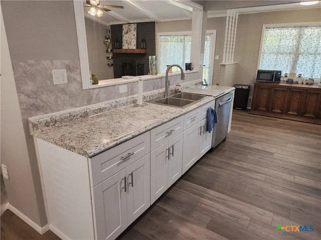 a kitchen with lot of counter space and wooden floor