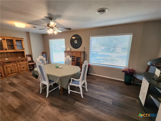 a view of a dining room with furniture and a chandelier
