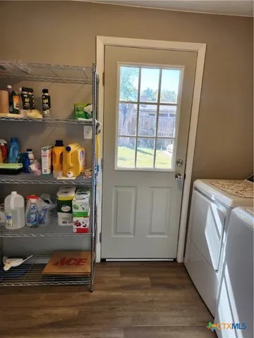 a view of washer and dryer with kitchen in the background