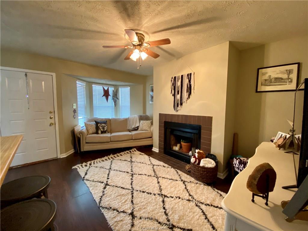 a living room with furniture and a fireplace