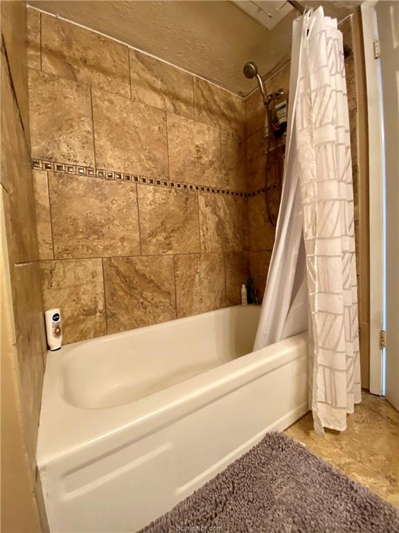 4441 Old College Road, Unit 4203 Bryan, TX 77801 - Photo 4 of 6 a bathroom with a bathtub and shower