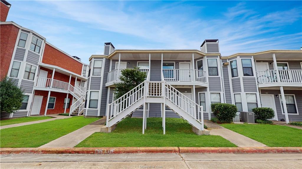4441 Old College Road, Unit 4203 Bryan, TX 77801 - Photo 6 of 6 a front view of a house with a yard