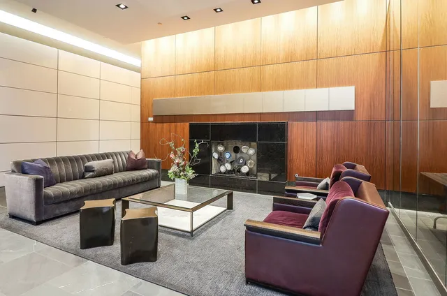 a living room with furniture a window and stainless steel appliances