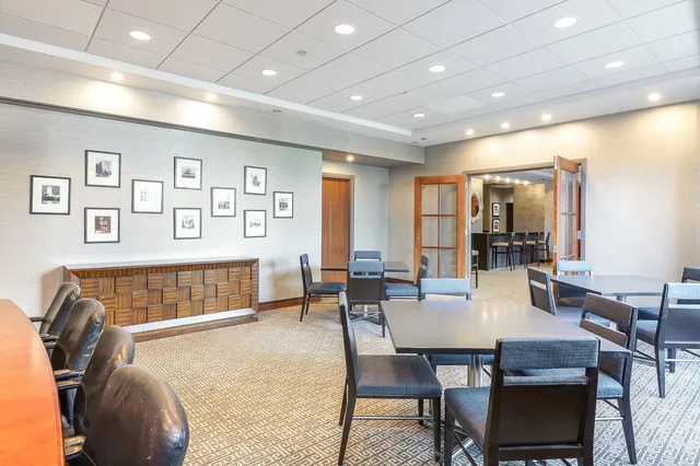 a view of a balcony with chairs and a potted plant