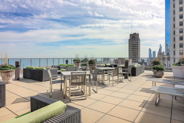 a view of a patio with dining table and chairs