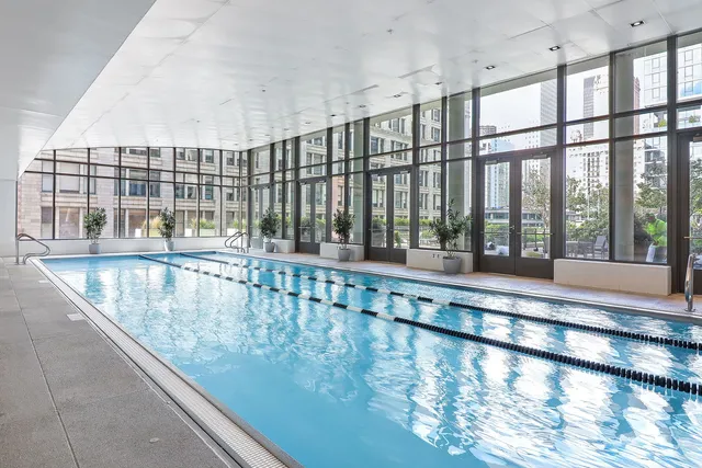 a bedroom with furniture and a large window