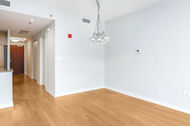 a kitchen with a refrigerator sink and cabinets