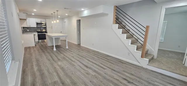a view of a kitchen with furniture and wooden floor
