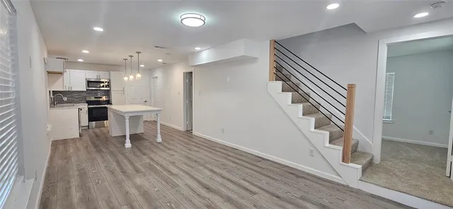 a dining room with furniture and a wooden floor