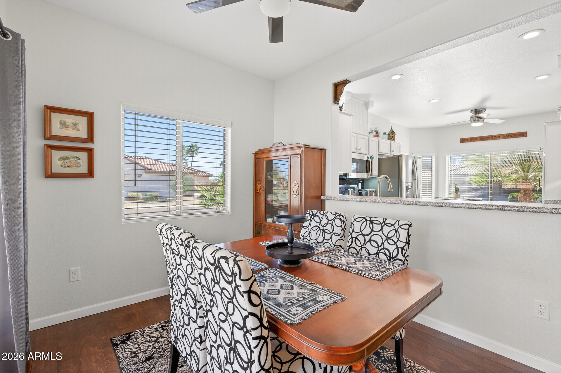 16100 West Eagle Ridge Drive Surprise, AZ 85374 - Photo 16 of 44 a view of a dining room with furniture window and wooden floor