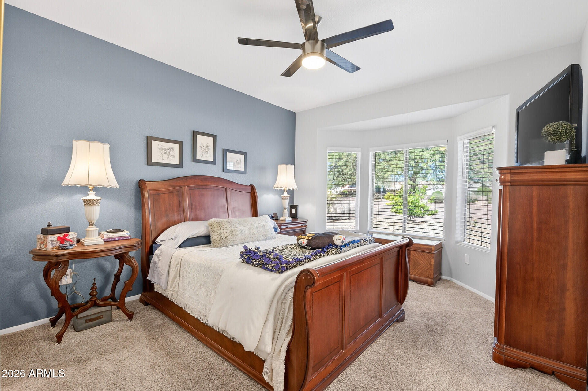 16100 West Eagle Ridge Drive Surprise, AZ 85374 - Photo 19 of 44 a bedroom with a bed and a chandelier