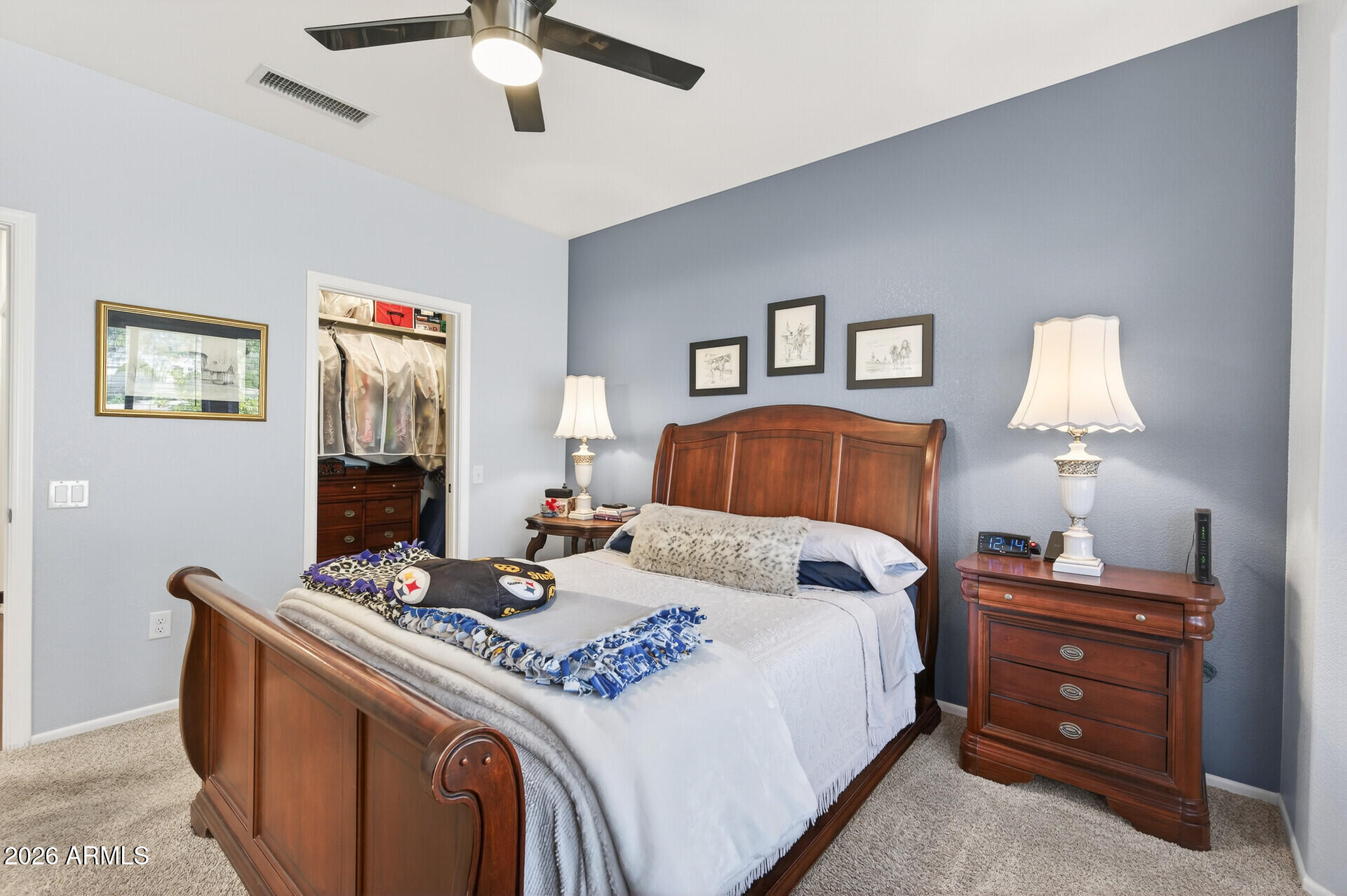 16100 West Eagle Ridge Drive Surprise, AZ 85374 - Photo 21 of 44 a bedroom with a bed and a chandelier