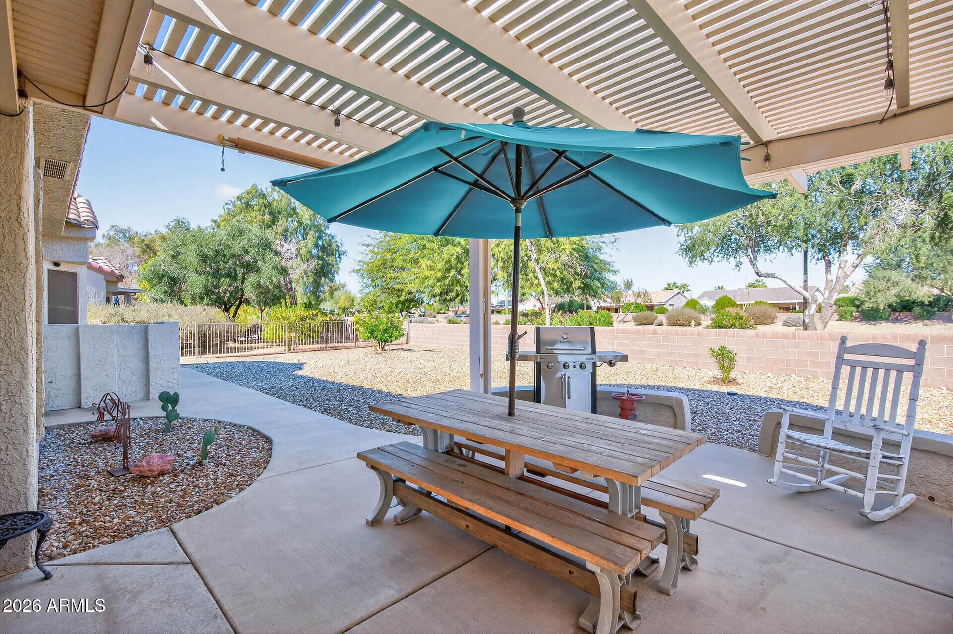 16100 West Eagle Ridge Drive Surprise, AZ 85374 - Photo 36 of 44 a view of a patio with table and chairs under an umbrella