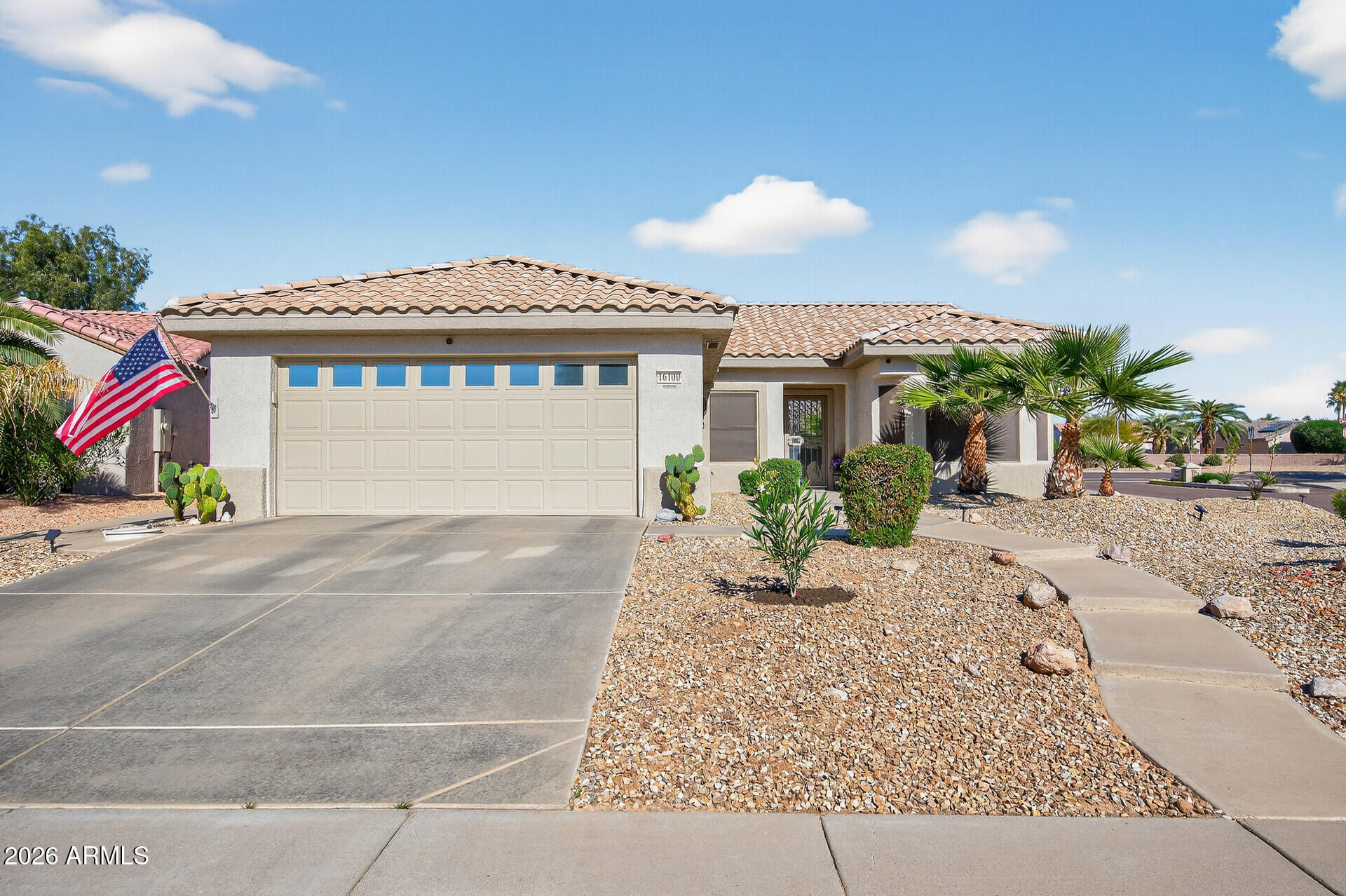 16100 West Eagle Ridge Drive Surprise, AZ 85374 - Photo 4 of 44 a front view of a house with a yard and potted plants