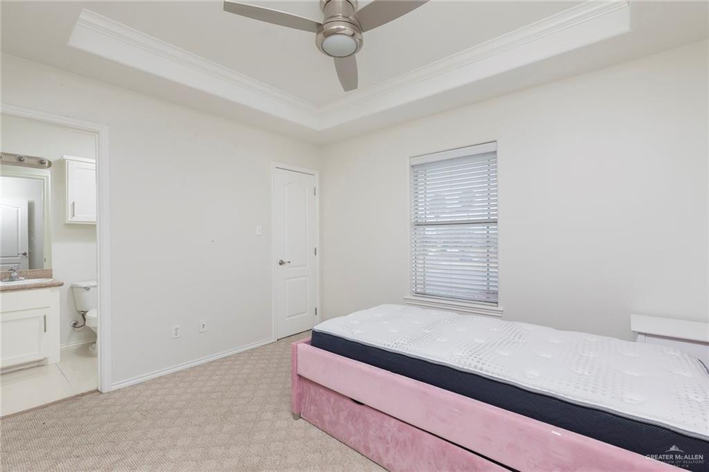 103 South 48th Lane, Unit 1 McAllen, TX 78501 - Photo 13 of 20 a bedroom with a bed and a chandelier