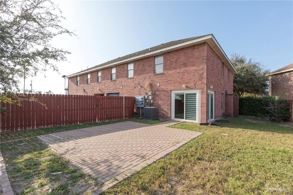 103 South 48th Lane, Unit 1 McAllen, TX 78501 - Photo 17 of 20 a front view of a house with a yard and garage