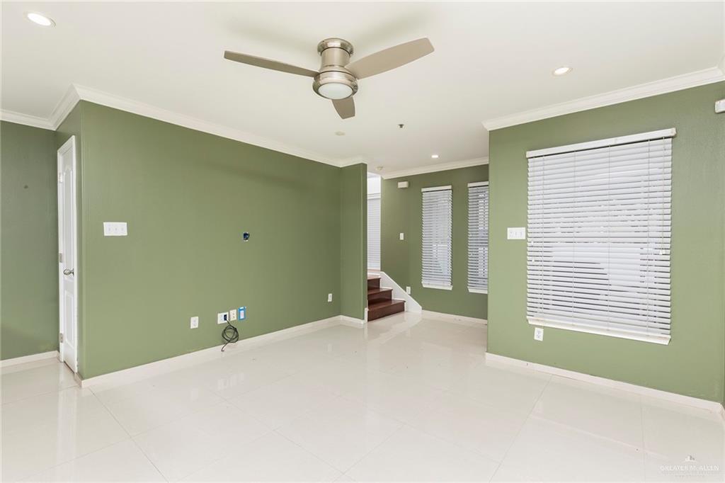 103 South 48th Lane, Unit 1 McAllen, TX 78501 - Photo 3 of 20 a bedroom with a large bed and a chandelier