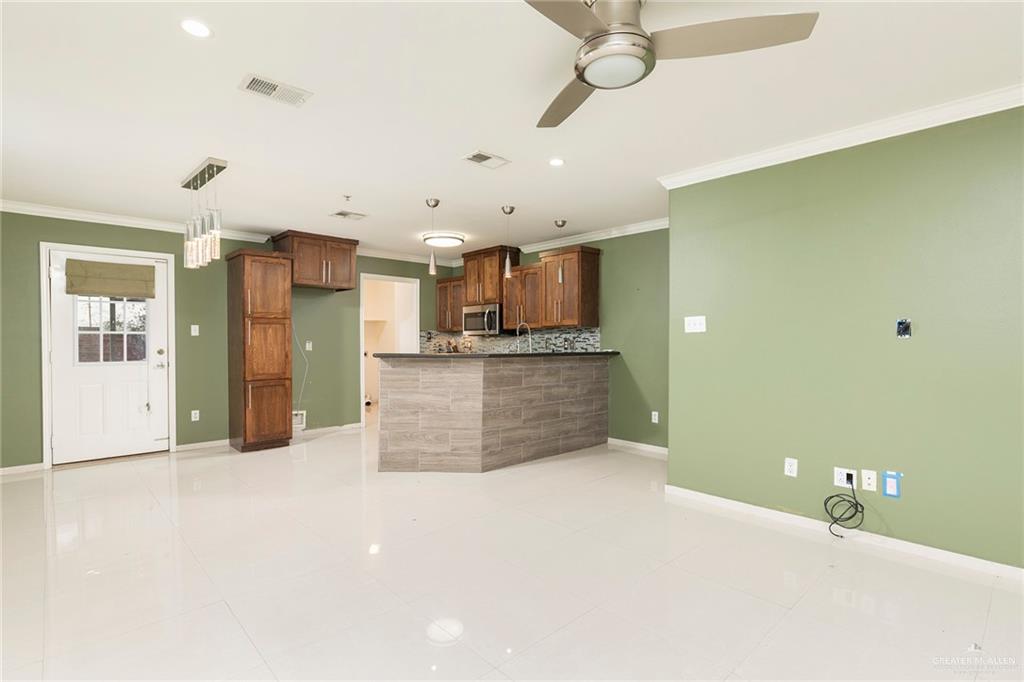 103 South 48th Lane, Unit 1 McAllen, TX 78501 - Photo 4 of 20 a large kitchen with stainless steel appliances a large counter top a stove and a refrigerator