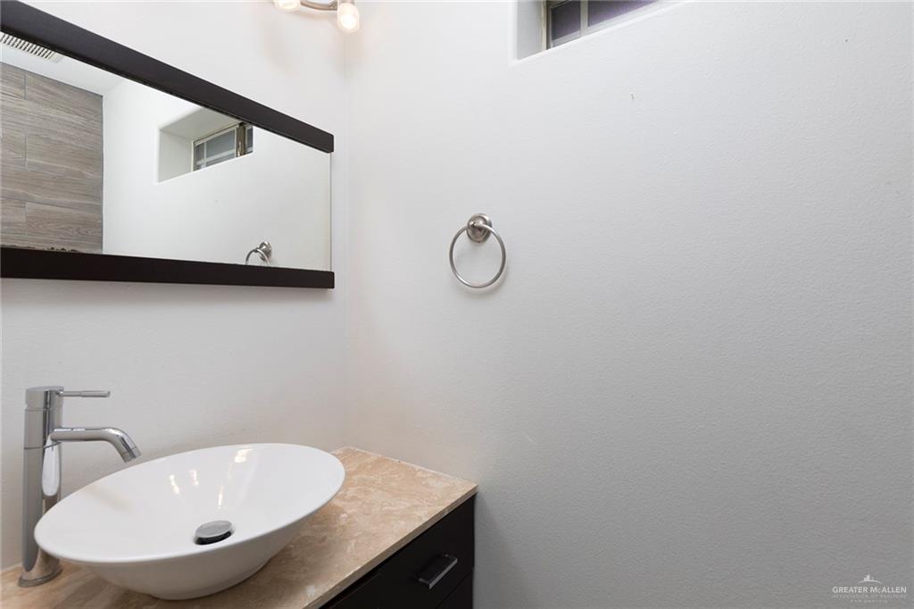 103 South 48th Lane, Unit 1 McAllen, TX 78501 - Photo 8 of 20 a bathroom with a sink and mirror