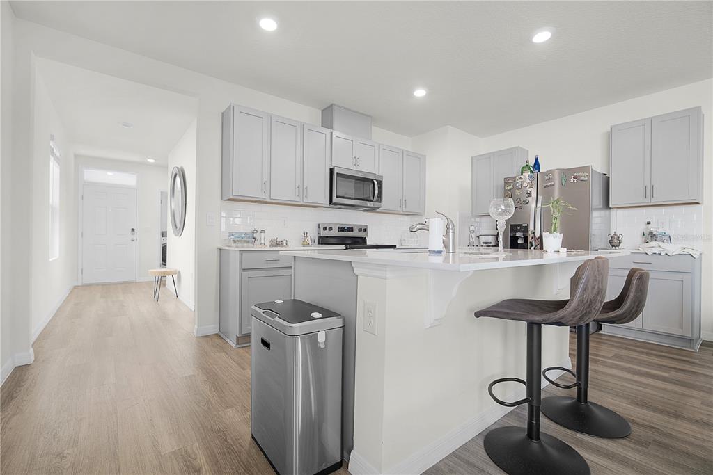 1606 Bull Hl Road Kissimmee, FL 34744 - Photo 20 of 38 a kitchen with kitchen island stainless steel appliances a sink and a refrigerator