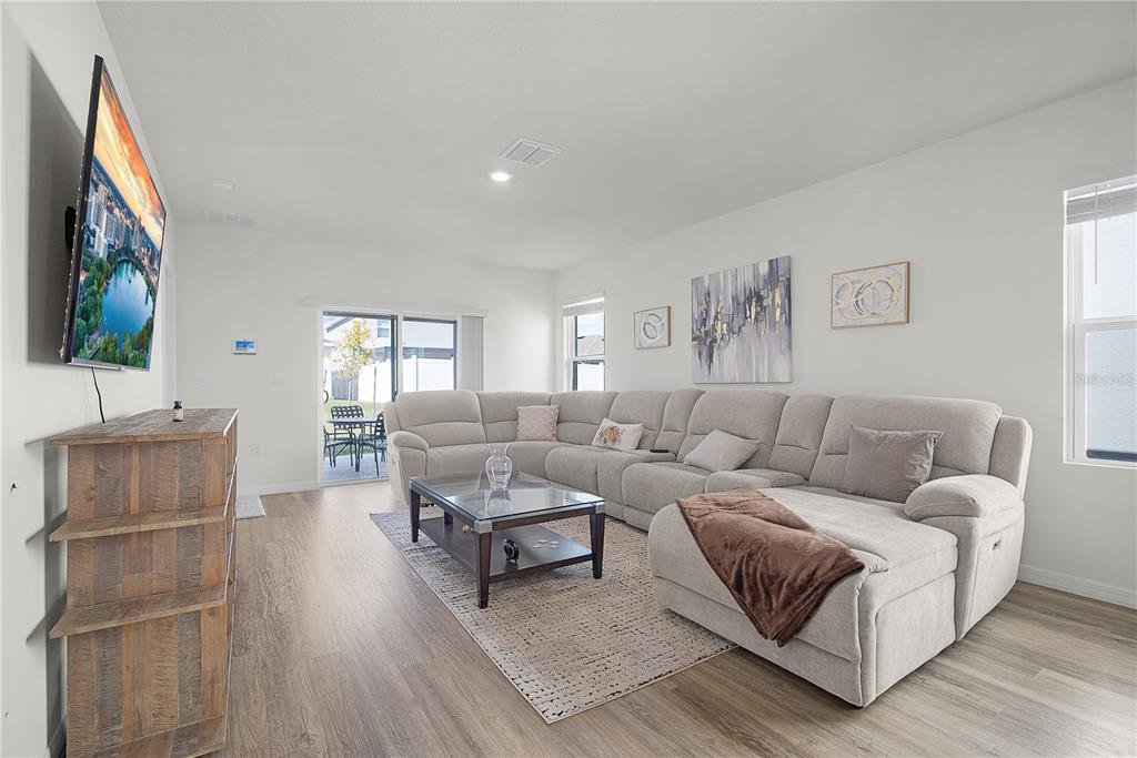 1606 Bull Hl Road Kissimmee, FL 34744 - Photo 25 of 38 a living room with furniture and a flat screen tv