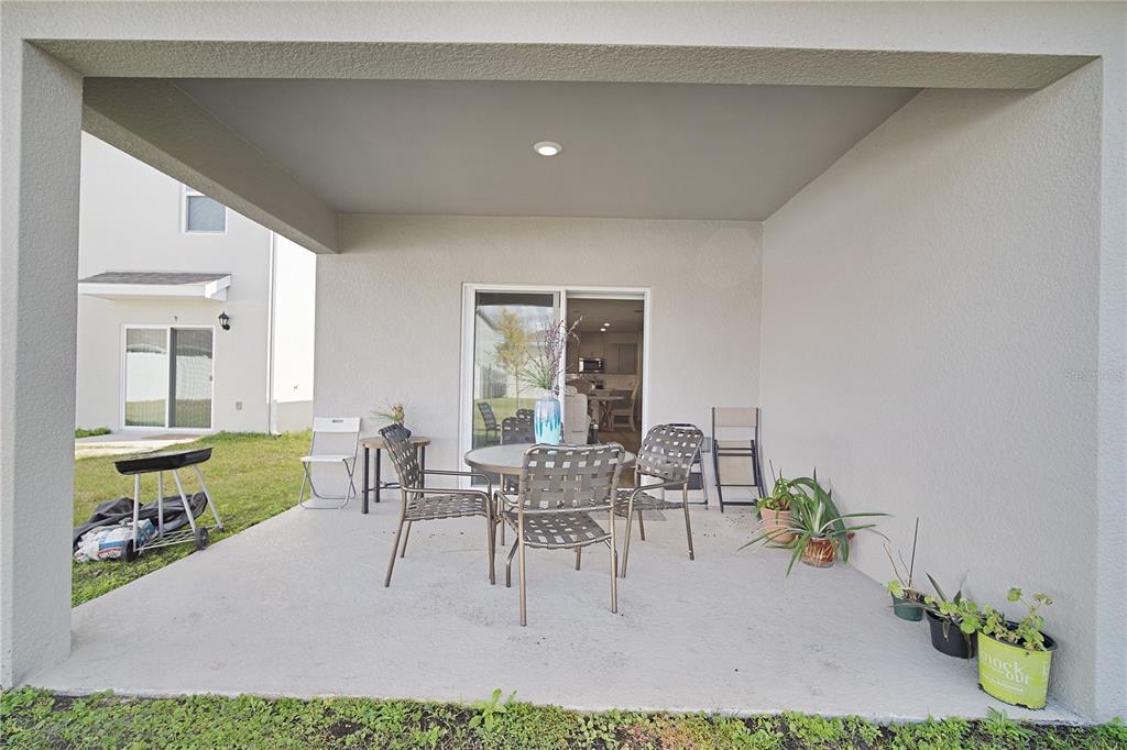 1606 Bull Hl Road Kissimmee, FL 34744 - Photo 35 of 38 a dining room with furniture and a potted plant