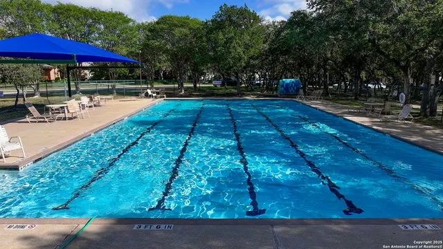 a view of a swimming pool with sitting area