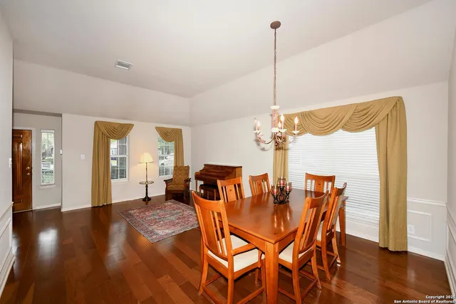 a dining room with furniture and wooden floor
