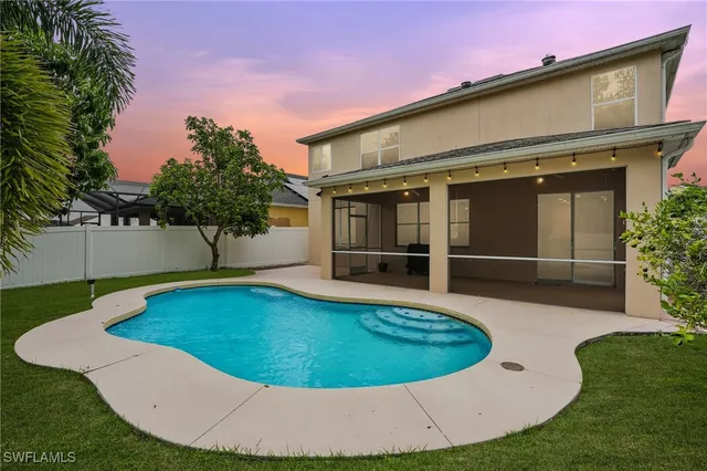 a view of a swimming pool with an outdoor seating