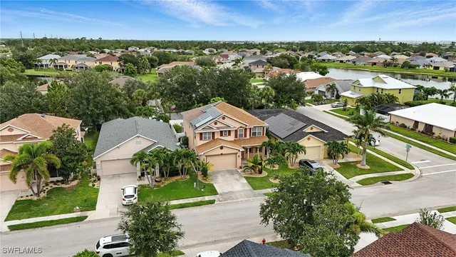 an aerial view of residential houses with outdoor space and street view