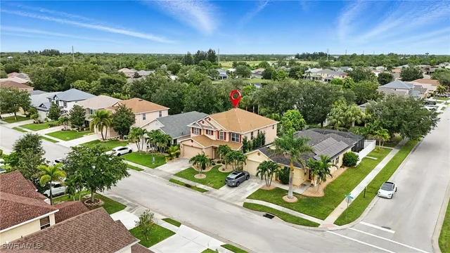 an aerial view of residential houses with outdoor space and street view