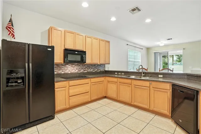 a kitchen with granite countertop cabinets and refrigerator