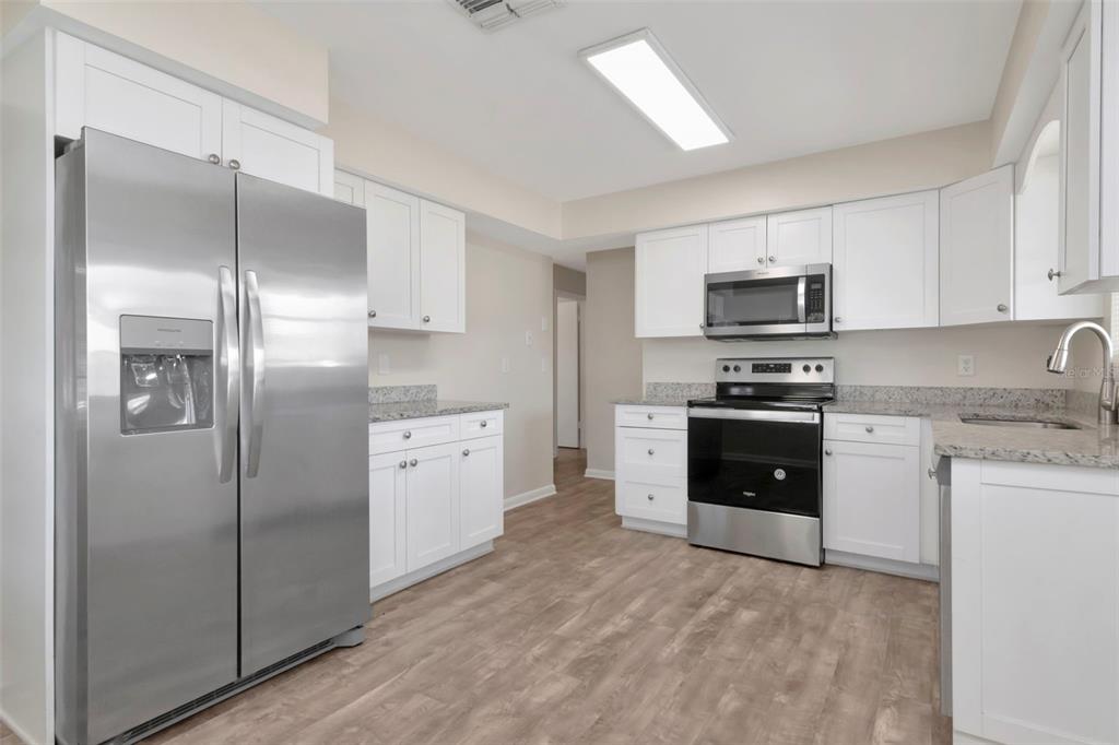 126 Kingsway Road Brandon, FL 33510 - Photo 20 of 42 a kitchen with a refrigerator stove and microwave