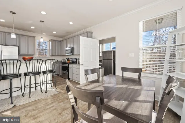a kitchen with center island table and chairs